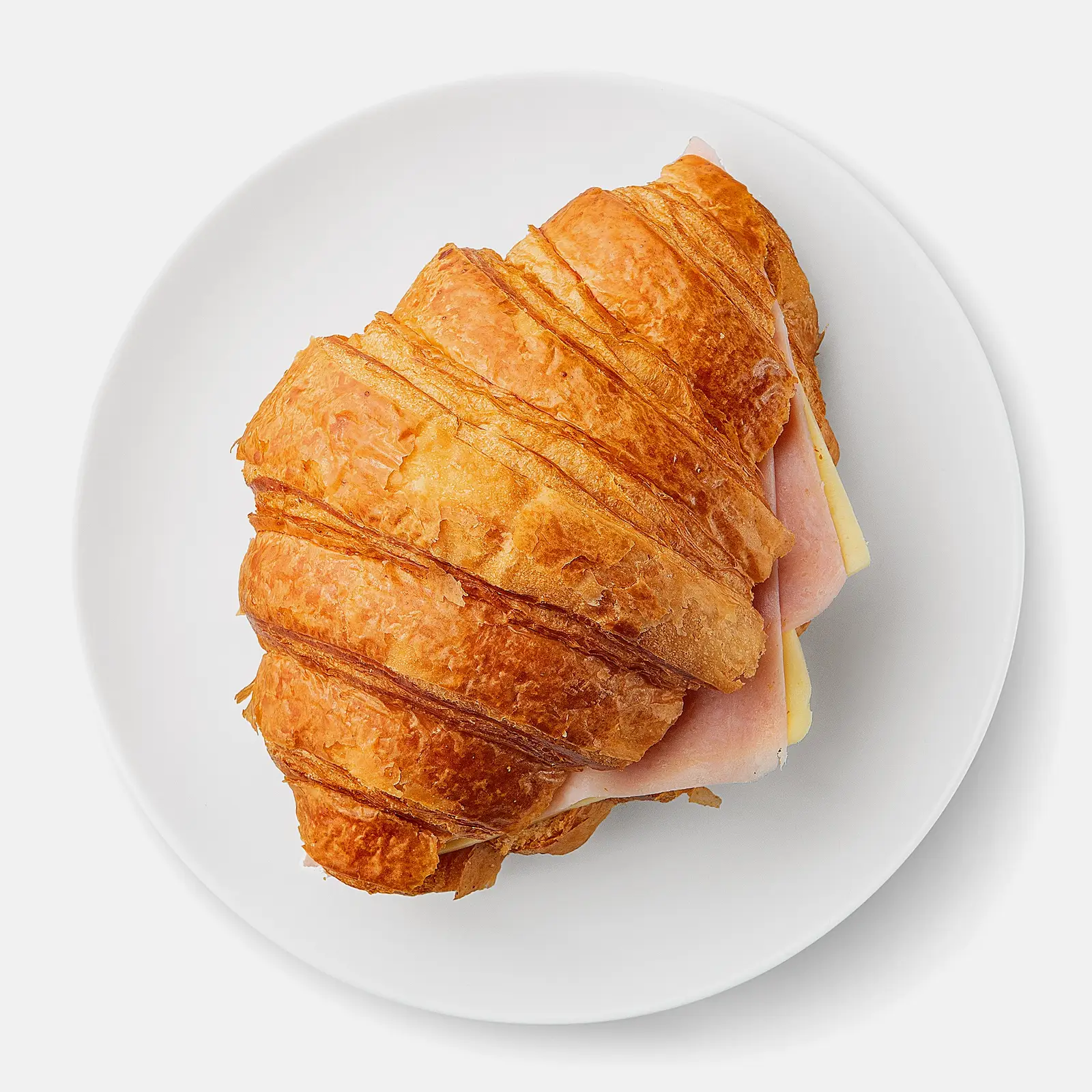 Изображение товара Круассан со свиной ветчиной и сыром 110г - хрустящая выпечка с вкусной начинкой